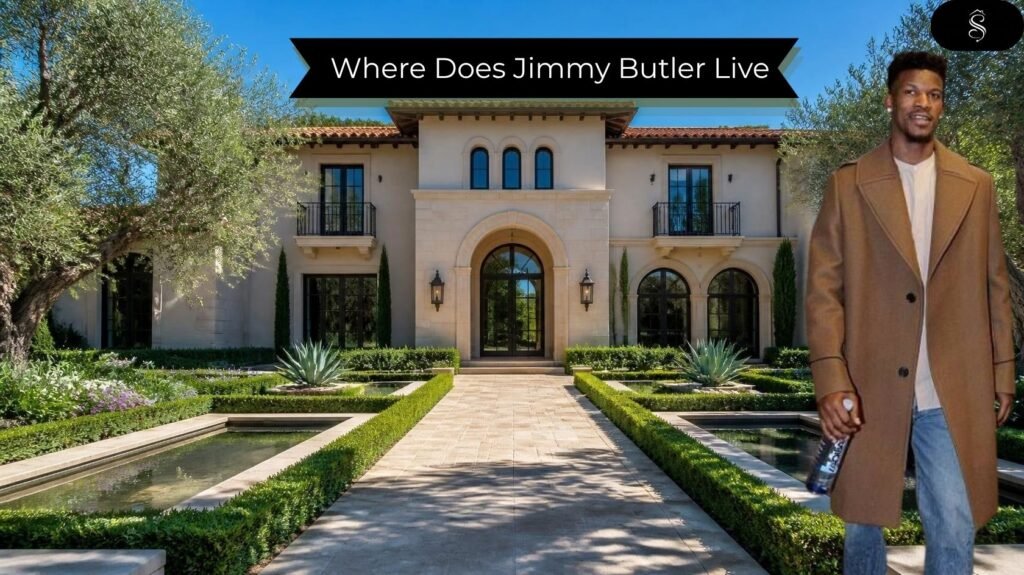 Where does Jimmy Butler live: front view of a Mediterranean-style California mansion with a stone arched entrance, terracotta roof, olive trees, and a manicured hedge garden with reflecting pools, and a man in a camel coat standing at the right