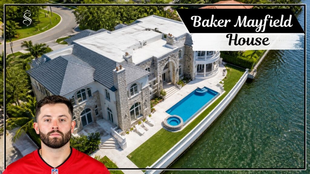 Aerial view of a large gray stone waterfront mansion with a pool and curved balconies on a Tampa Bay island