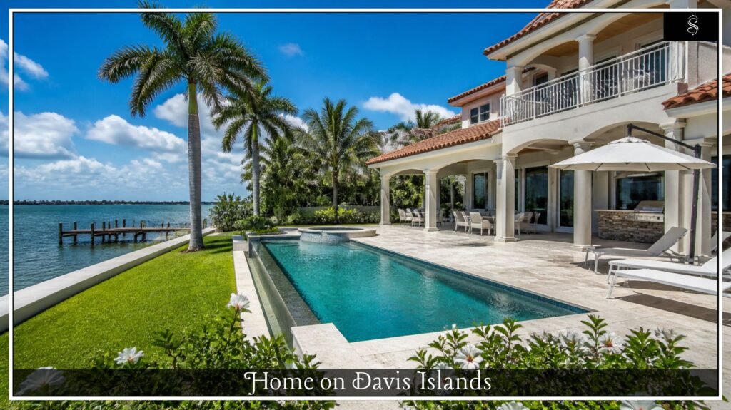Waterfront backyard with an infinity pool, private dock and palm trees at a Tampa Bay island home